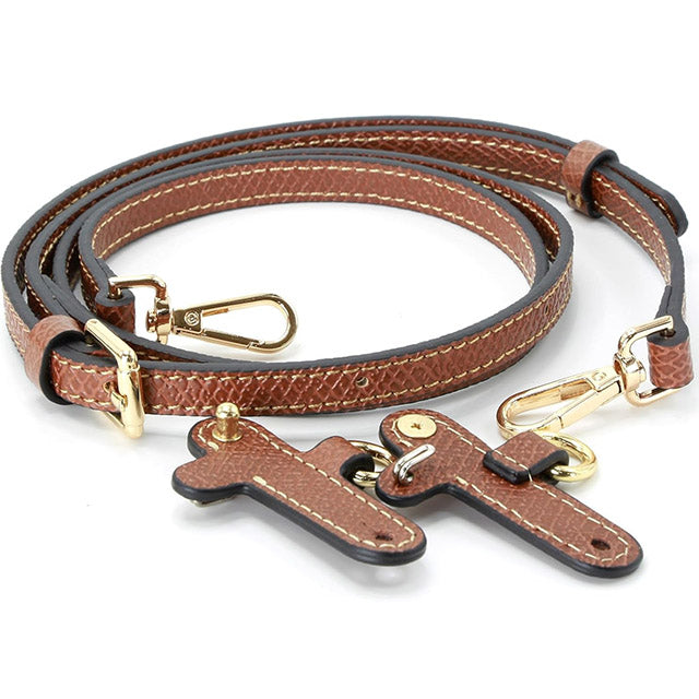Transformez votre sac en une pièce exceptionnelle avec cette bandoulière ajustable en cuir authen...